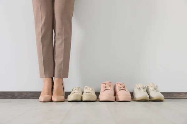Businesswoman High Heel Shoes Comfortable Sneakers Indoors Closeup — Stockfoto