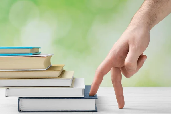 Man Climbing Stairs Books Fingers White Wooden Table Blurred Background — Foto de Stock