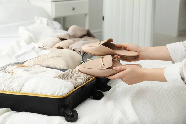 Woman Holding Fashionable Shoes Open Suitcase Bedroom Closeup — Zdjęcie stockowe