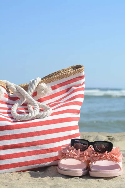 Stylish Striped Bag Slippers Sunglasses Sandy Beach Sea — Photo
