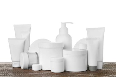Set of different cosmetic products on wooden table against white background