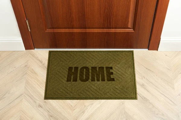 Door mat with word Home near entrance door