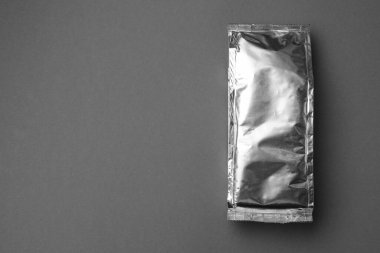Blank foil package on grey background, top view. Space for text