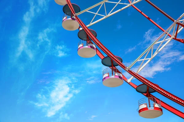 Beautiful large Ferris wheel against blue sky, low angle view