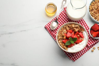 Flat lay composition with tasty granola and ingredients served on white marble table. Space for text
