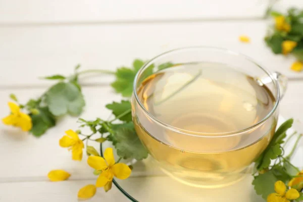 Glass Cup Aromatic Celandine Tea Flowers White Wooden Table Closeup — ストック写真
