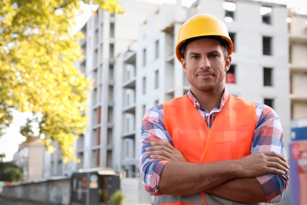 Professional engineer in safety equipment at construction site