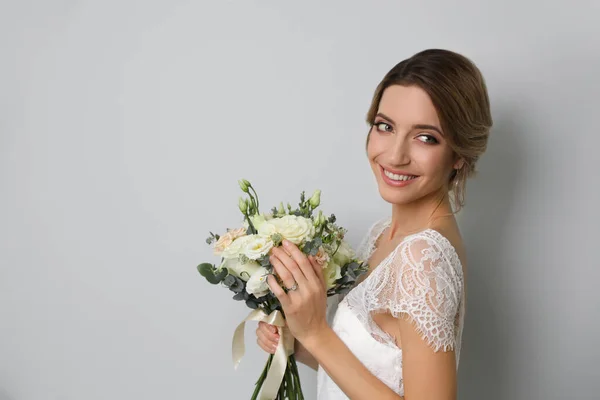 Young Bride Elegant Hairstyle Holding Wedding Bouquet Light Grey Background — Zdjęcie stockowe
