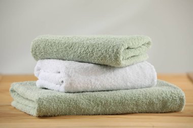 Stack of folded towels on wooden table