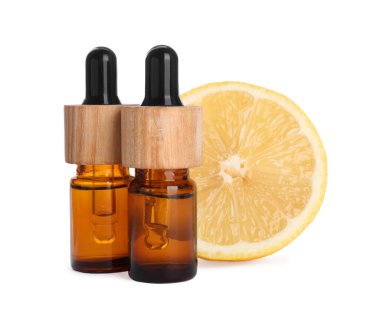 Bottles of citrus essential oil and fresh lemon isolated on white