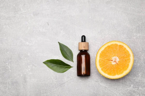 Bottle Essential Oil Orange Slice Leaves Grey Stone Table Flat — Zdjęcie stockowe