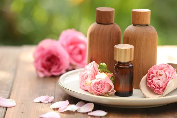 Bottles Rose Essential Oil Flowers Wooden Table Outdoors Space Text — Zdjęcie stockowe