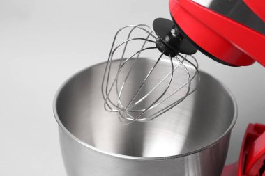 Modern red stand mixer on light grey background, closeup