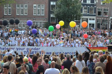 AMSTERDAM, NETHERLANDS - AUGUST 06, 2022: Many people at LGBT pride parade on summer day