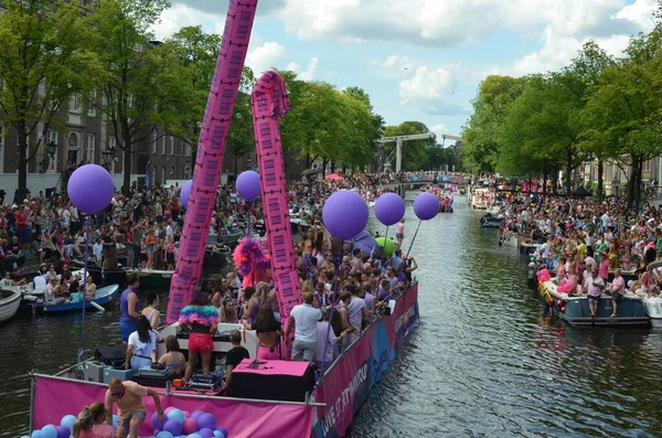AMSTERDAM, NETHERLANDS - AUGUST 06, 2022: Many people in boats at LGBT pride parade on river