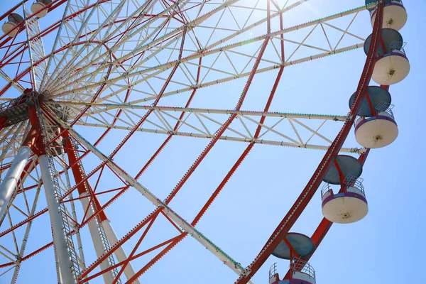 Beautiful large Ferris wheel against blue sky, low angle view
