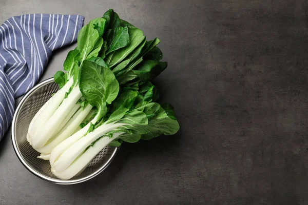 Fresh Green Pak Choy Cabbages Water Drops Sieve Grey Table — Stockfoto