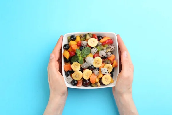 Woman Delicious Exotic Fruit Salad Light Blue Background Top View — Stockfoto