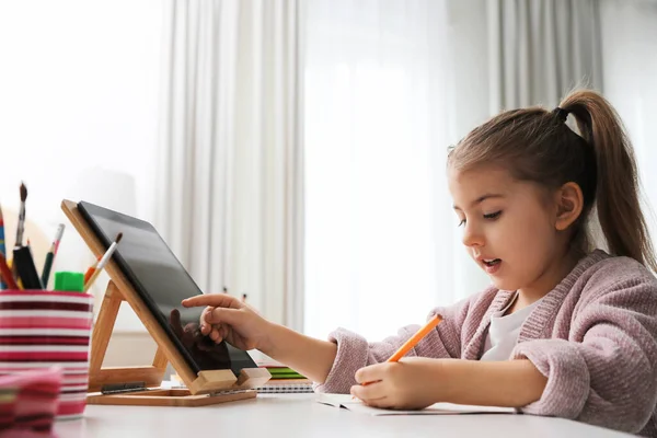 Adorable Little Girl Doing Homework Tablet Table Indoors — Stock fotografie