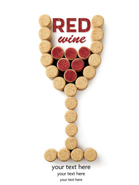 Glass of wine made with corks on white background, top view. Space for design