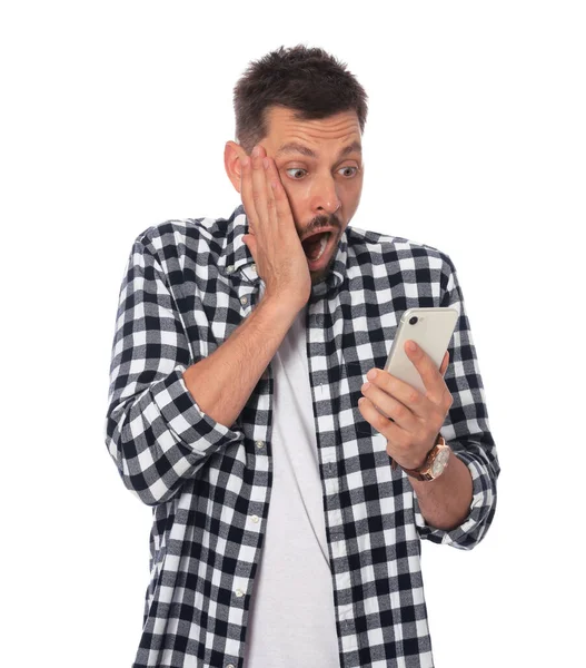 Emotional Man Looking Smartphone White Background — Zdjęcie stockowe