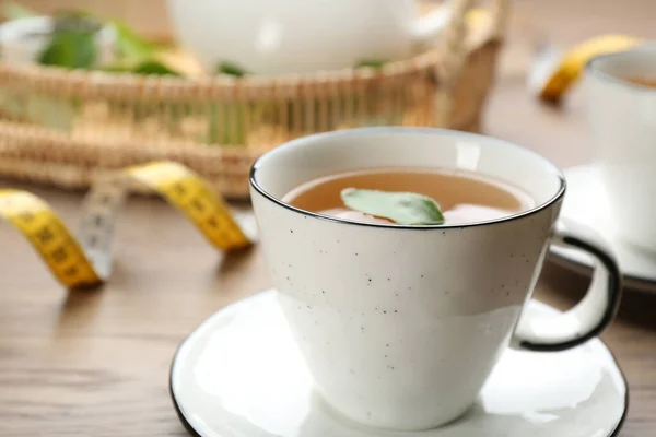 Cup Herbal Diet Tea Measuring Tape Wooden Table Closeup — Zdjęcie stockowe