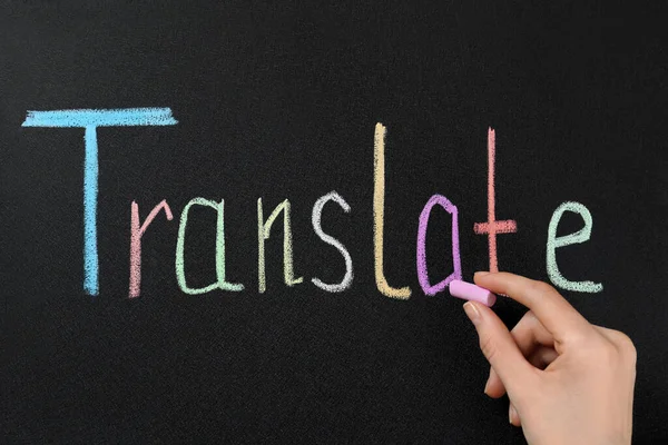 Woman Writing Word Translate Chalk Blackboard Closeup — Stock Photo, Image