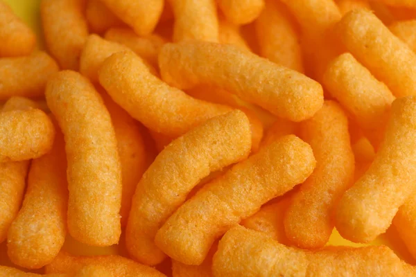 Tasty Cheesy Corn Puffs Background Closeup — 图库照片