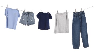 Different clothes drying on washing line against white background