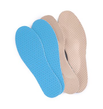 Pairs of insoles on white background, top view