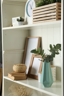 White shelving unit with different decorative elements
