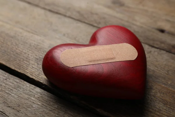 Heart Medical Patch Wooden Table Closeup Relationship Problems Concept —  Fotos de Stock