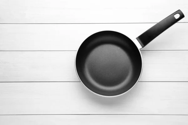 New Non Stick Frying Pan White Wooden Table Top View — Stockfoto