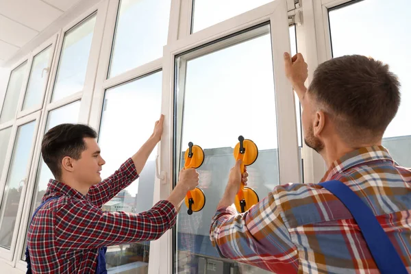 Workers Using Suction Lifters Plastic Window Installation Indoors — 图库照片
