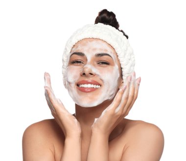 Beautiful woman applying facial cleansing foam on white background