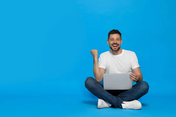 Happy Man Sitting Laptop Light Blue Background Space Text — Fotografia de Stock