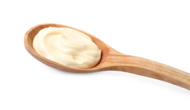 Mayonnaise in wooden spoon isolated on white, closeup