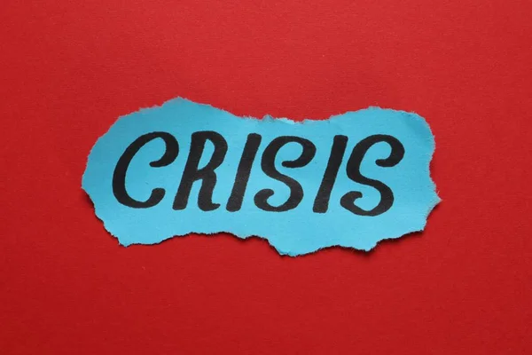 Piece Paper Word Crisis Red Background Closeup — Foto Stock