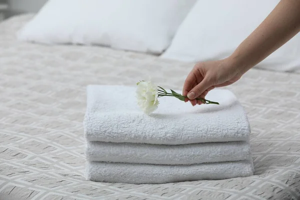 Woman Putting Eustoma Flower Folded Towels Bedroom Closeup — 图库照片