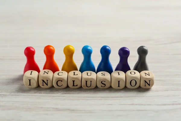 Colorful Pawns Cubes Word Inclusion White Wooden Table — Fotografia de Stock