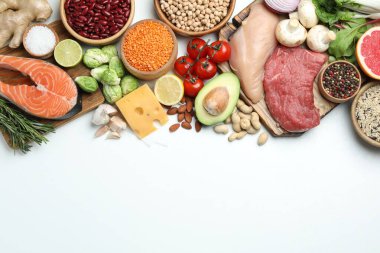 Flat lay composition with fresh meat and other products on white background, space for text. Balanced diet