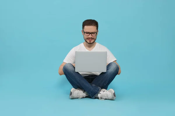 Smiling Man Sitting Using Laptop Light Blue Background — Photo