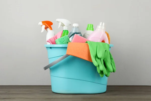 Light Blue Bucket Cleaning Products Wooden Table — Zdjęcie stockowe