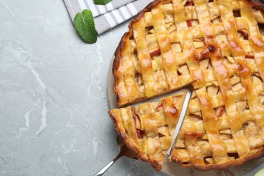 Fresh traditional apple pie on light grey table, flat lay. Space for text