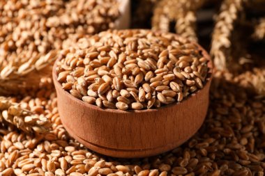 Closeup view of bowl and wheat grains