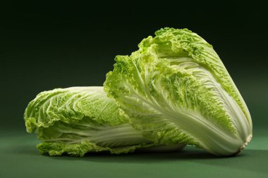 Fresh ripe Chinese cabbages on green background