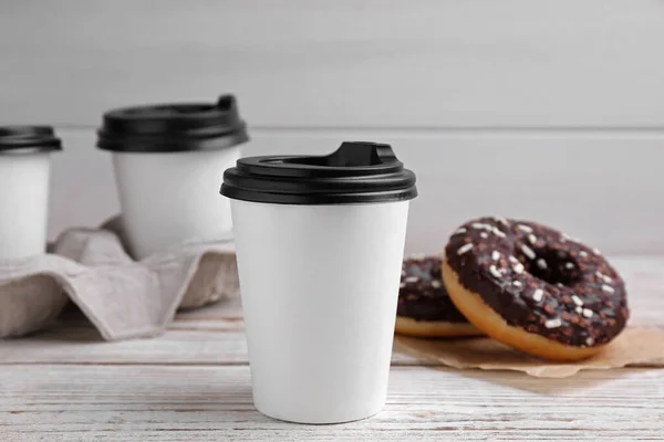 Cups Hot Drinks Tasty Donuts White Wooden Table — Stock Fotó