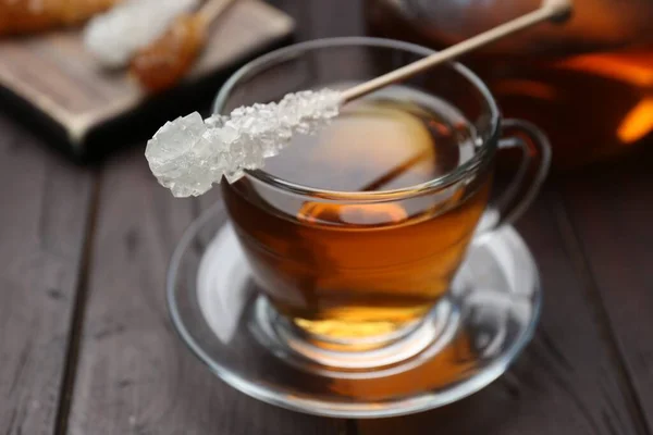 Stick Sugar Crystals Cup Tea Wooden Table Closeup — стоковое фото