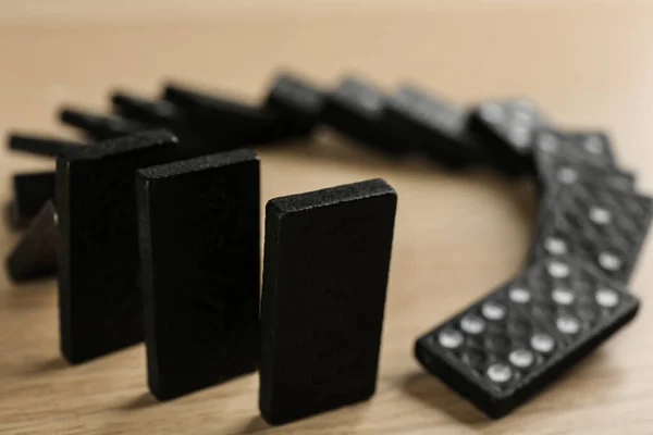 Black Domino Tiles Falling Wooden Table Closeup — Foto de Stock