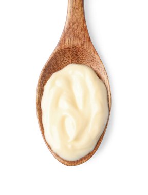 Mayonnaise in wooden spoon isolated on white, top view